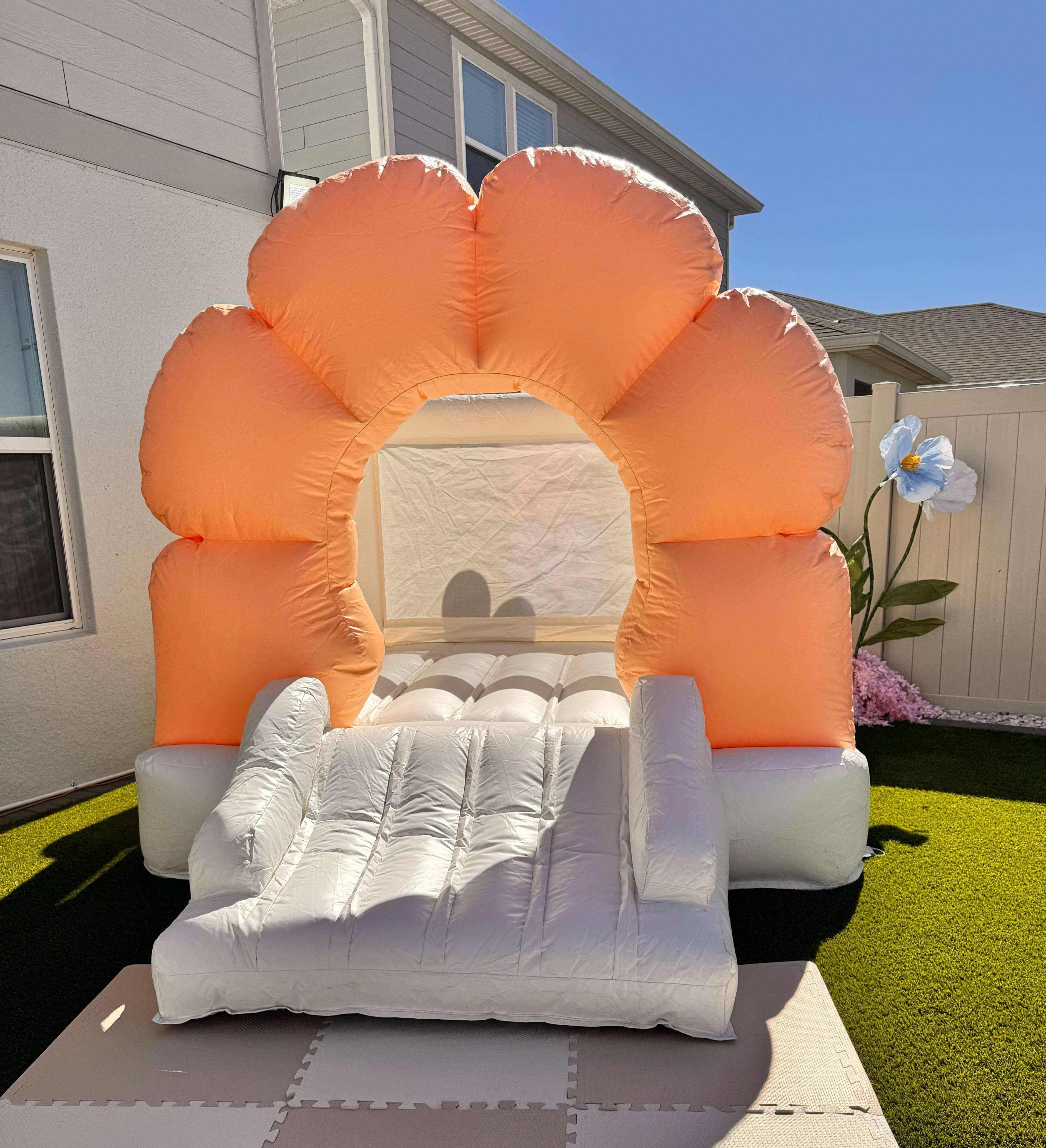 Daisy-themed flower bounce house with slide