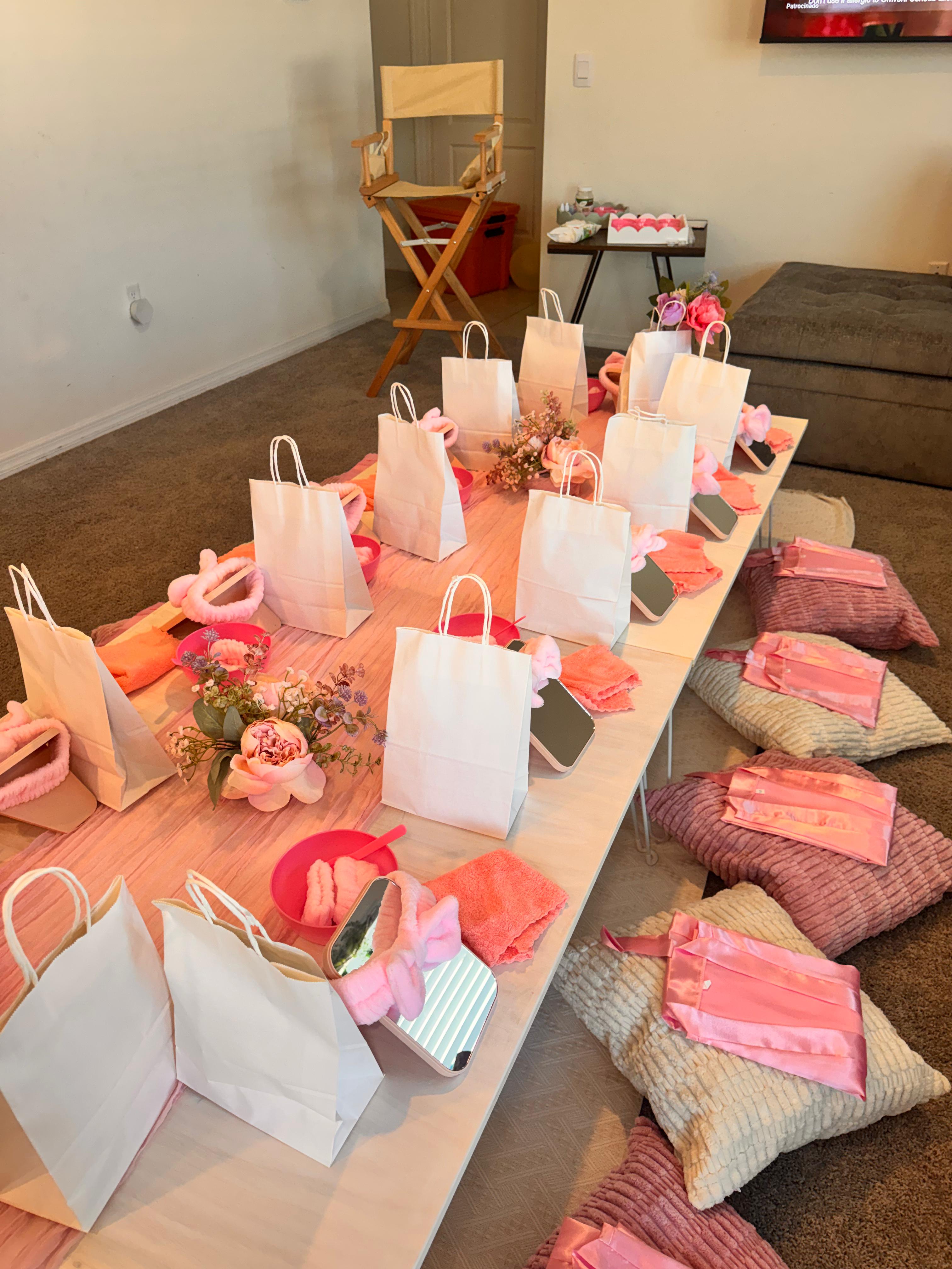 Sparkle Spa party setup with mini salon stations, pink balloons and celebration table